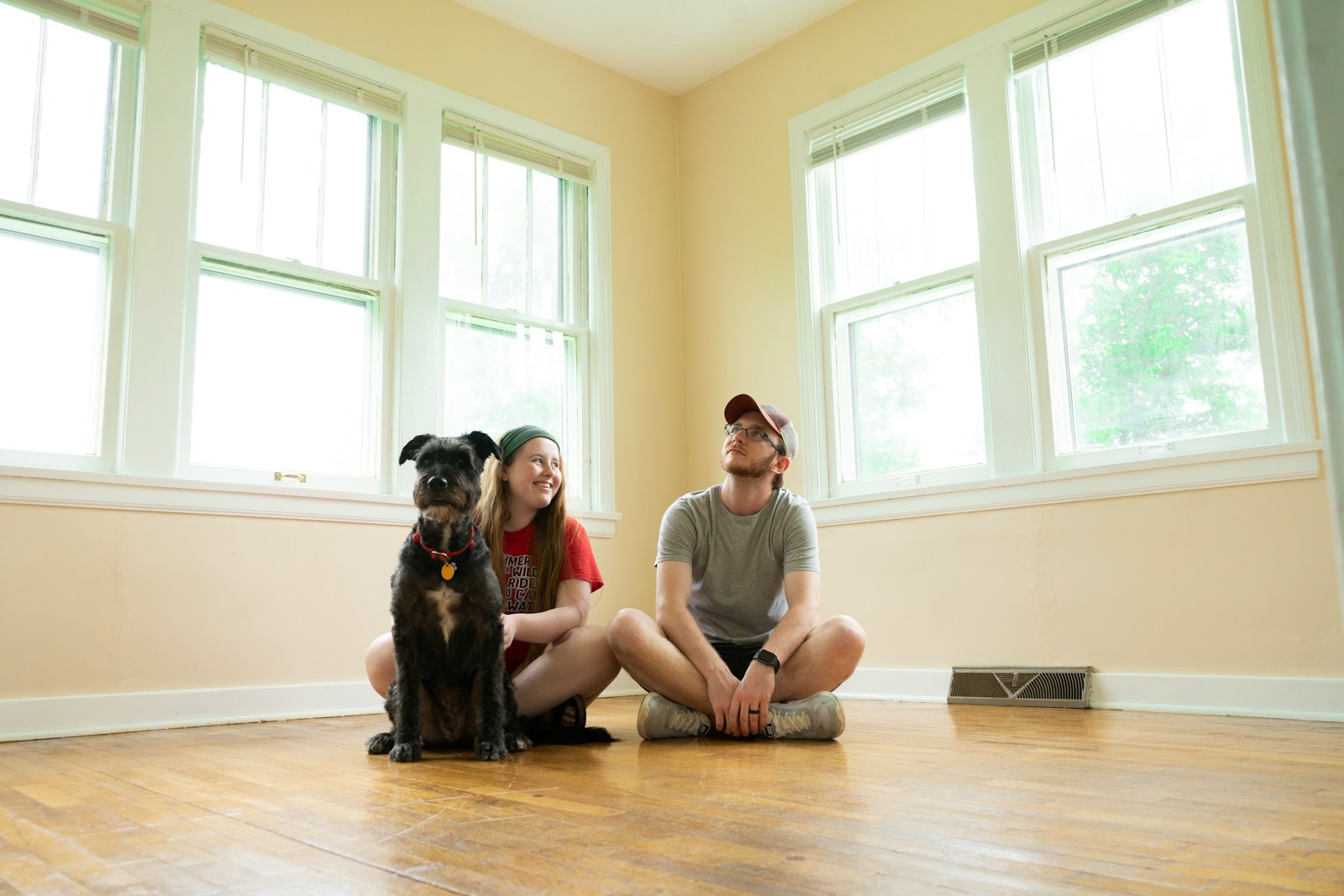 woman in gray shirt sitting on brown wooden floor, home insurance